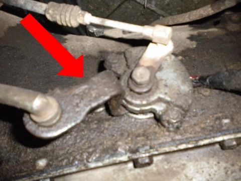 1989 Ford Bronco - Detail of a vehicle's transmission linkage mechanism, showing mechanical components.