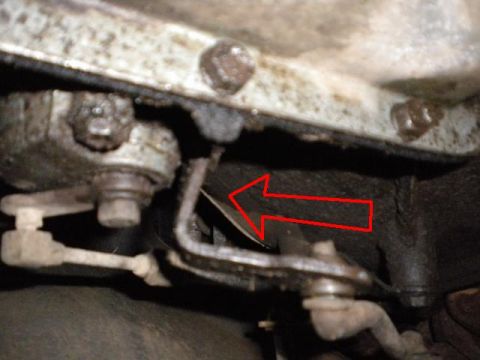 1989 Ford Bronco - Undercarriage view shows mechanical linkage with a red arrow indicating a specific component.