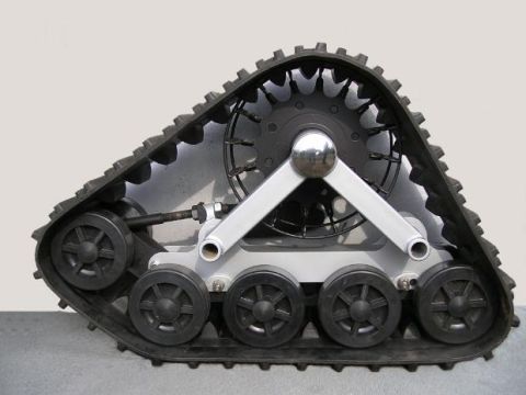1987 Suzuki Samurai - This snow track assembly features a robust black rubber track and a complex silver metal suspension system.