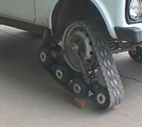 1987 Suzuki Samurai - A vehicle is equipped with snow tracks, replacing the traditional wheels.