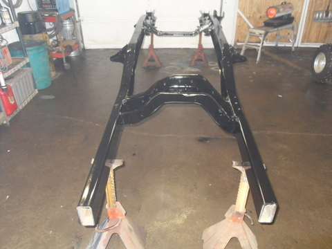 1997 Ford Ranger - Vehicle frame assembly on jack stands, likely undergoing restoration or repair.