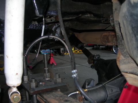 1991 Jeep Wrangler - Close-up view of the rear axle and suspension components of a vehicle, possibly undergoing modification.