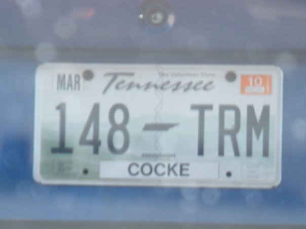 Tennessee license plate 148-TRM with Cocke county sticker on a blue vehicle