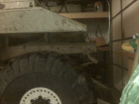 1992 Ford F-350 - Close-up view of a truck's frame and tire, suggesting a heavy-duty vehicle, possibly in a workshop or garage environment.