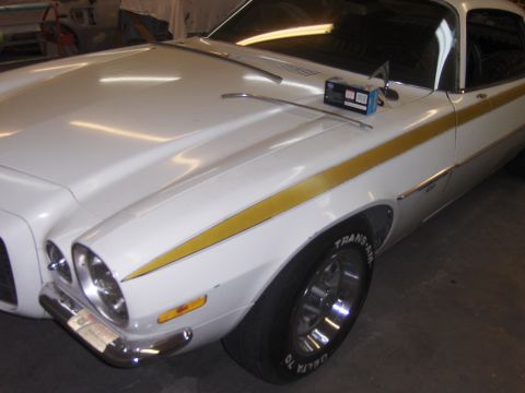 1971 Chevrolet Camaro - This white Chevrolet features a gold stripe along its side and appears to be a 1973 model.