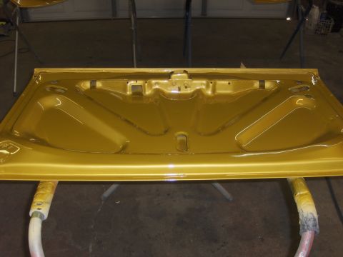 1971 Chevrolet Camaro - Underside of a gold car hood, freshly painted and awaiting reinstallation.