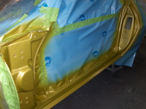 1971 Chevrolet Camaro - A car door interior is masked for painting, revealing the raw metal underneath.