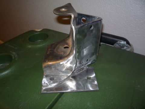 1979 Ford Bronco - Metal bracket part shown on a green cooler. No vehicle visible.