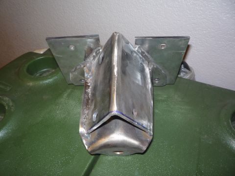1979 Ford Bronco - A shop-fabricated bare steel skid plate or crossmember bracket with a V-shaped center channel and two flat drilled mounting flanges welded…