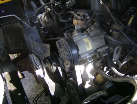 1994 Ford Bronco - The engine bay shows various components like the AC compressor, alternator, and fan assembly.