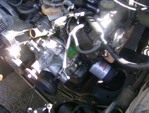 1994 Ford Bronco - Close-up view of an engine compartment, focusing on the oil filter and associated components.