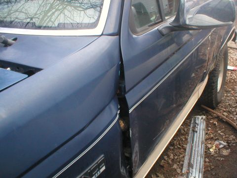 1993 Ford Bronco - Close-up of the driver's side door gap on a blue 1993 Ford Bronco.