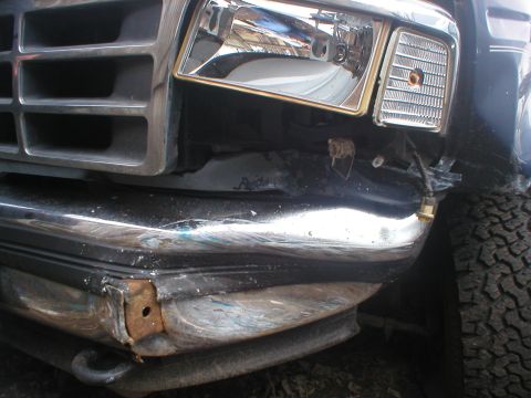 1993 Ford Bronco - The front end of the vehicle shows significant damage to the bumper and headlight area.
