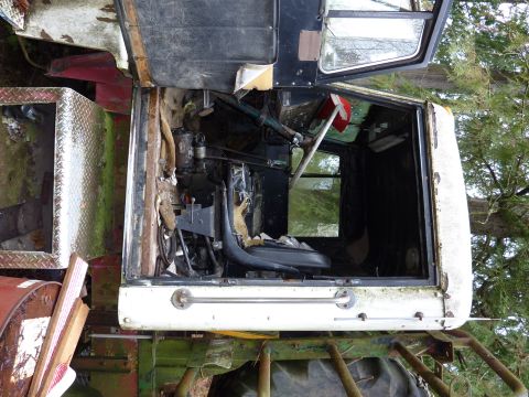 1981 Kenworth W900A - The interior of a truck cab is shown, with damaged seats and visible mechanical components.