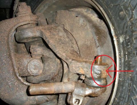 1992 Ford F-350 - This image shows a close-up of a vehicle's suspension system, specifically a ball joint. No year is discernible.