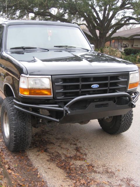 1994 Ford Bronco - This truck features a heavy-duty aftermarket bumper with a winch mount, suggesting off-road modifications.