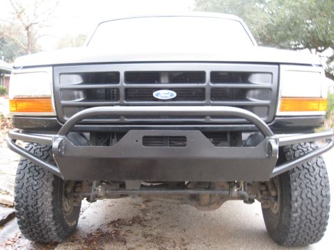 1994 Ford Bronco - This 1994 Ford Bronco features a robust aftermarket bumper and a classic grille, its front profile.