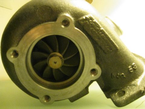 1994 Ford Probe - Close-up of a turbocharger's compressor housing, showing the impeller and mounting flange.