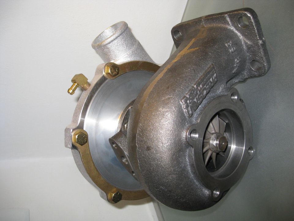 Turbocharger with silver and cast iron housings, showing compressor wheel