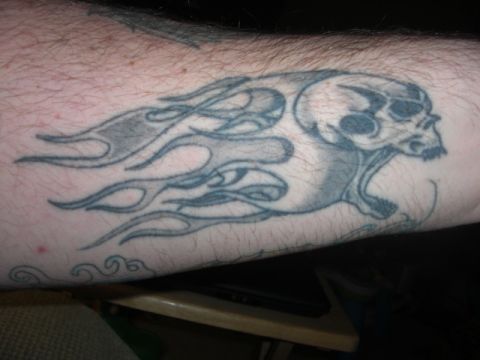 1994 Ford Bronco - A tattoo of a skull with flames is visible on an arm.