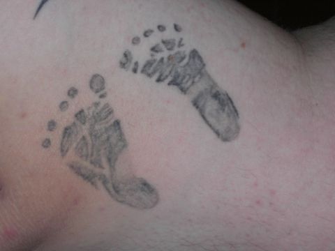 1994 Ford Bronco - A tattoo depicting two baby footprints.