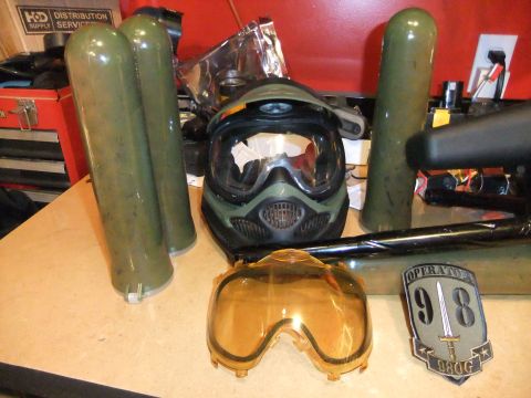 1978 Chevrolet C/K Pickup - Paintball gear including a mask, spare lens, and air tanks are laid out on a surface.
