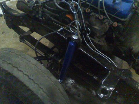 1979 Ford F-250 - Close-up view of engine and suspension components, including a blue shock absorber, with a Supermotors watermark.