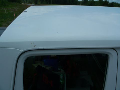 1979 Ford F-250 - White pickup truck roof shows signs of rust and wear.
