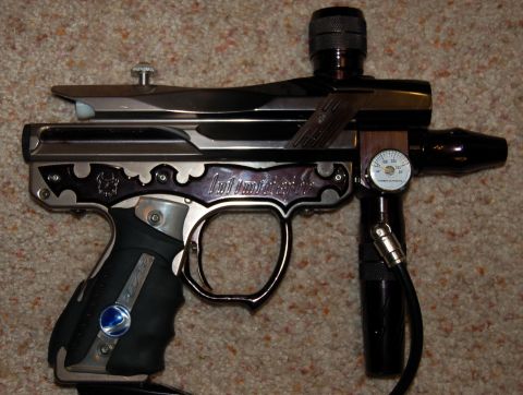 1994 Ford Bronco - A paintball marker with decorative accents and a visible pressure gauge is shown against a carpeted background.