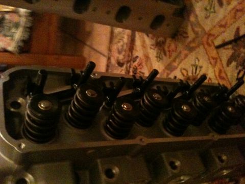 1972 Ford Ranchero - Close-up of a freshly rebuilt cylinder head laying on its side, showing a row of installed valve springs, retainers, and rocker studs with…