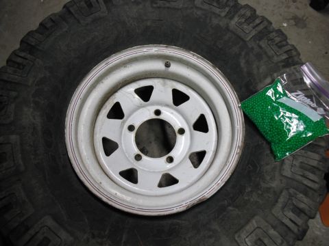 1991 Ford Bronco - A tire and wheel assembly, with a bag of balancing beads, is shown for bead balancing.