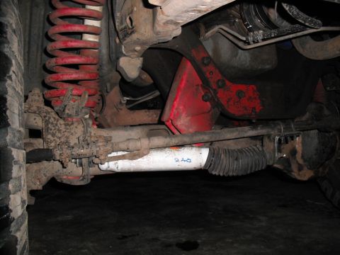 1991 Ford Bronco - Close-up of the undercarriage, focusing on suspension parts and steering linkage.