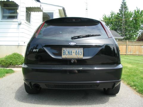 2003 Ford Focus - The rear of a black 2003 Ford Focus SVT hatchback is shown parked in a driveway.