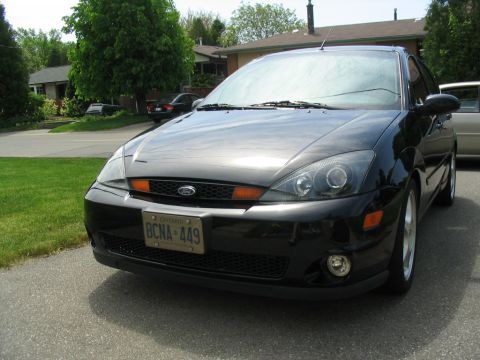2003 Ford Focus - Front view of a black 2003 Ford Focus sedan parked on a residential street.