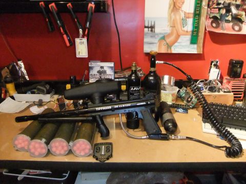 1978 Chevrolet C/K Pickup - A collection of paintball gear and other items are arranged on a workbench.