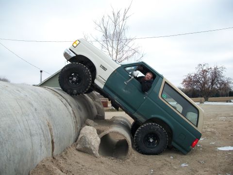 1989 Ford Bronco - A modified Ford Bronco navigates an off-road obstacle course.