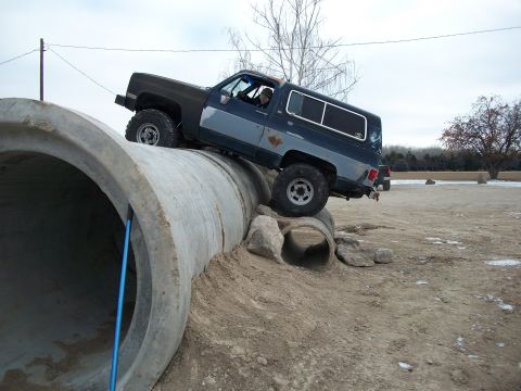 1989 Ford Bronco - This Chevrolet K5 Blazer is navigating an obstacle course made of large concrete pipes.
