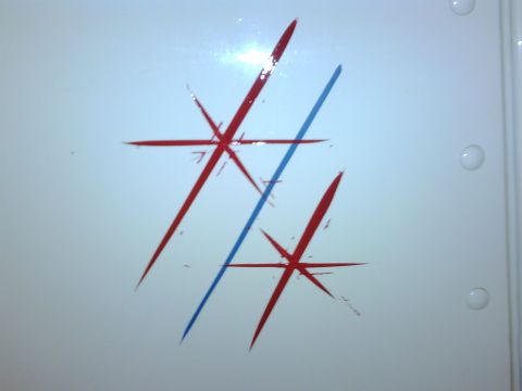 2003 Peterbilt 379 - A white surface displays a graphic design red abstract starbursts and a blue line, with a Supermotors.net watermark.