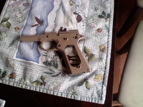 1979 Ford Bronco - A tan gun frame rests on a decorative table runner birds and foliage.