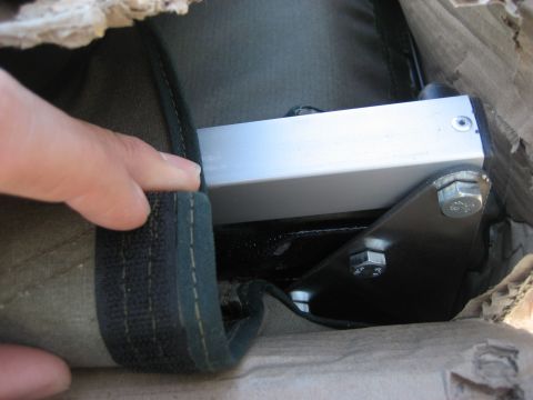 1996 Ford Bronco - A metal bracket and bolts are visible on a fabric cover, possibly part of a tent or vehicle accessory.