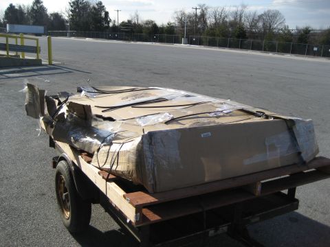 1996 Ford Bronco - Damaged cargo on a trailer parked outdoors.