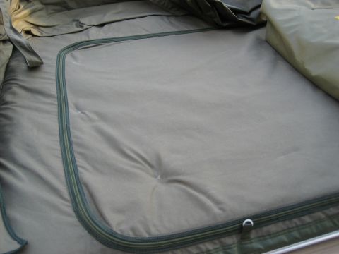 1996 Ford Bronco - Close-up of the interior of a green tent, highlighting the zippered closure and fabric texture.