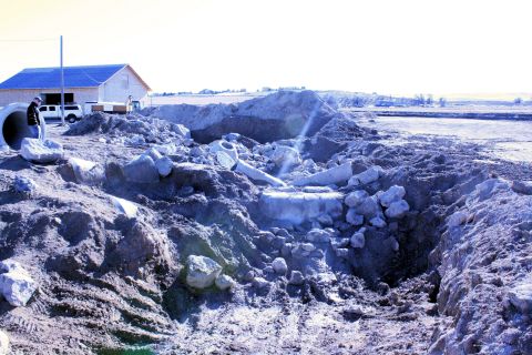 1989 Ford Bronco - A white pickup truck is visible at a construction site with piles of dirt and debris.