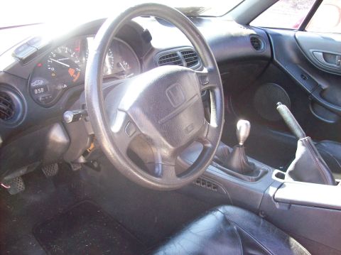 1989 Ford Bronco - The interior of a car is shown, a manual transmission and a dashboard with gauges.