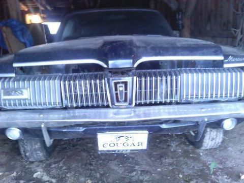 1968 Mercury Cougar - The front grille of a 1968 Mercury Cougar, the model name and year on a badge.
