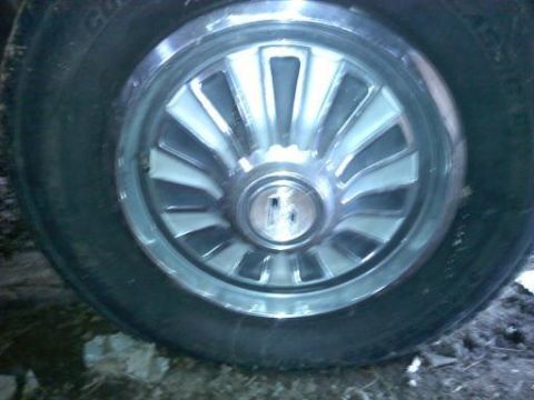 1968 Mercury Cougar - This is a close-up view of a car's wheel cover and tire.