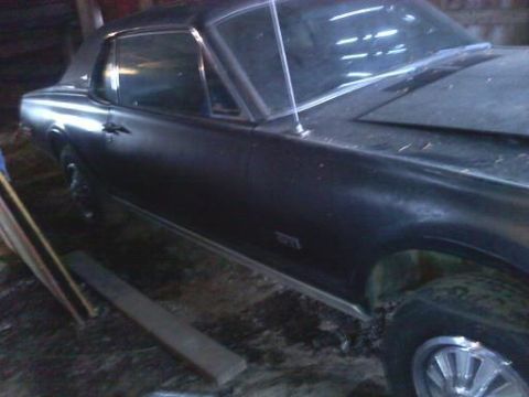 1968 Mercury Cougar - Side profile of a 1968 Mercury Cougar coupe, appears to be in storage.