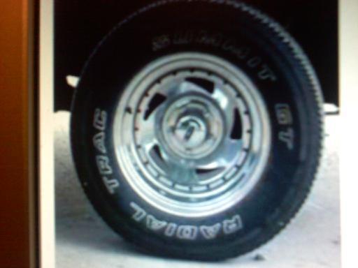Chrome wheel with 'TRAC' and 'RADIAL' text on tire