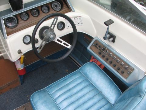 1968 Ford Mustang - The interior of a boat shows a dashboard with gauges and a steering wheel.