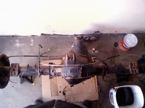 1996 Ford Bronco - A rear axle assembly is shown from above, with various components and a can of paint nearby.